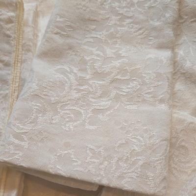 LOT 150: Linens Including Rectangle Tablecloths, Small Round Table Clothes, Table Scarves, Napkins, and More