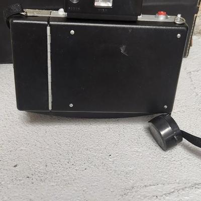 Sale Photo Thumbnail #946: Excellent condition. Polaroid 101, case, cold meter thingie, flashbulbs, book