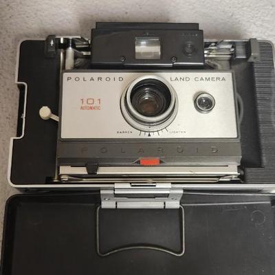 Sale Photo Thumbnail #948: Excellent condition. Polaroid 101, case, cold meter thingie, flashbulbs, book