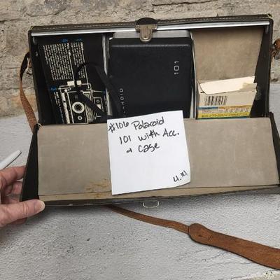Sale Photo Thumbnail #943: Excellent condition. Polaroid 101, case, cold meter thingie, flashbulbs, book