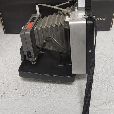 Sale Photo Thumbnail #947: Excellent condition. Polaroid 101, case, cold meter thingie, flashbulbs, book