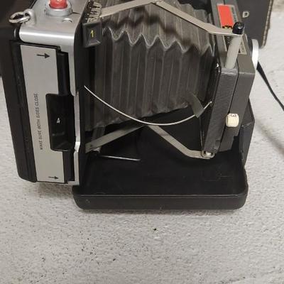 Sale Photo Thumbnail #945: Excellent condition. Polaroid 101, case, cold meter thingie, flashbulbs, book