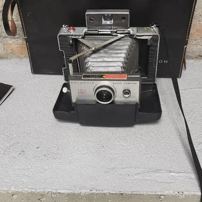 Sale Photo Thumbnail #944: Excellent condition. Polaroid 101, case, cold meter thingie, flashbulbs, book