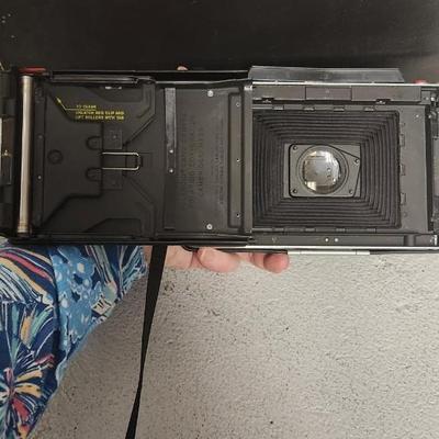 Sale Photo Thumbnail #949: Excellent condition. Polaroid 101, case, cold meter thingie, flashbulbs, book