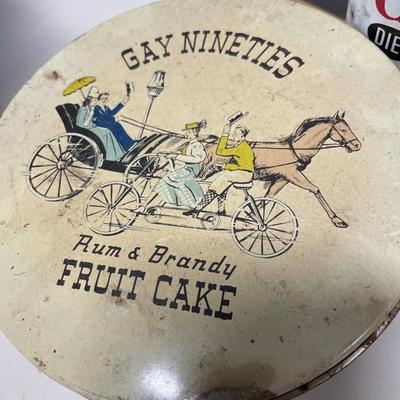 Fruitcake tin, cherry pop can and Eastman Kodak Co glass beaker