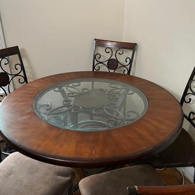 Sale Photo Thumbnail #22: Dark brown dining table with 5 matching chairs. Center has a glass inlay that shows off the table’s rustic design. 

Table has a superficial crack and a visible scratch in it as shown in the pictures. The crack has no impact on the integrity of the tabl