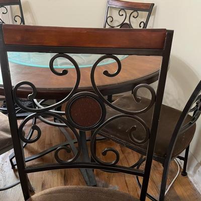 Sale Photo Thumbnail #23: Dark brown dining table with 5 matching chairs. Center has a glass inlay that shows off the table’s rustic design. 

Table has a superficial crack and a visible scratch in it as shown in the pictures. The crack has no impact on the integrity of the tabl
