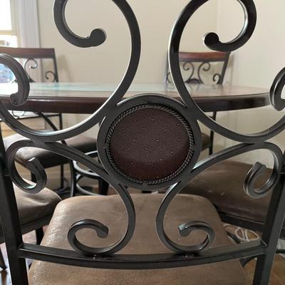 Sale Photo Thumbnail #24: Dark brown dining table with 5 matching chairs. Center has a glass inlay that shows off the table’s rustic design. 

Table has a superficial crack and a visible scratch in it as shown in the pictures. The crack has no impact on the integrity of the tabl