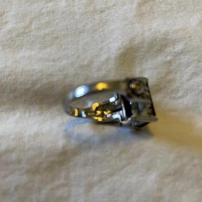 TWO LADIES RINGS. ONE LADIES STERLING SILVER RING ONE BLACK STONE SILVER TONE RING