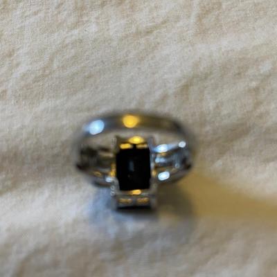 TWO LADIES RINGS. ONE LADIES STERLING SILVER RING ONE BLACK STONE SILVER TONE RING