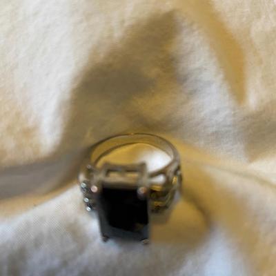 TWO LADIES RINGS. ONE LADIES STERLING SILVER RING ONE BLACK STONE SILVER TONE RING