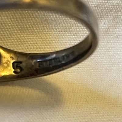 TWO LADIES RINGS. ONE LADIES STERLING SILVER RING ONE BLACK STONE SILVER TONE RING