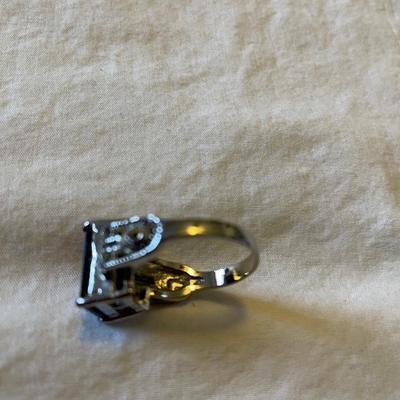 TWO LADIES RINGS. ONE LADIES STERLING SILVER RING ONE BLACK STONE SILVER TONE RING