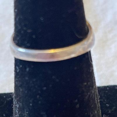 TWO LADIES RINGS. ONE LADIES STERLING SILVER RING ONE BLACK STONE SILVER TONE RING