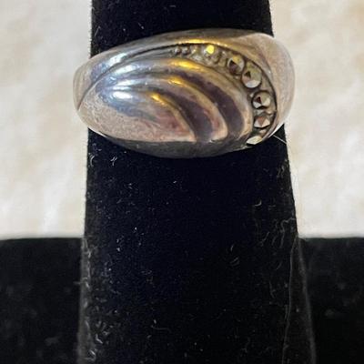 TWO LADIES RINGS. ONE LADIES STERLING SILVER RING ONE BLACK STONE SILVER TONE RING