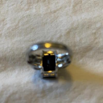TWO LADIES RINGS. ONE LADIES STERLING SILVER RING ONE BLACK STONE SILVER TONE RING
