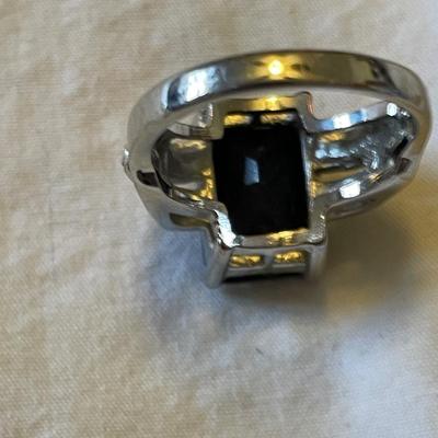 TWO LADIES RINGS. ONE LADIES STERLING SILVER RING ONE BLACK STONE SILVER TONE RING