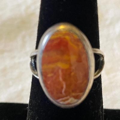 LADIES STERLING RING WITH ORANGE SPINY STONE AND AN ENAMELED BAND