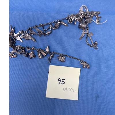 Sale Photo Thumbnail #474: Thought this was a bracelet, until I unfolded it!  Lots of great charms.
Not all charms may be sterling, but the majority of them are.  54.2 grams total weight.