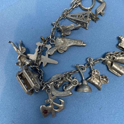 Sale Photo Thumbnail #475: Thought this was a bracelet, until I unfolded it!  Lots of great charms.
Not all charms may be sterling, but the majority of them are.  54.2 grams total weight.
