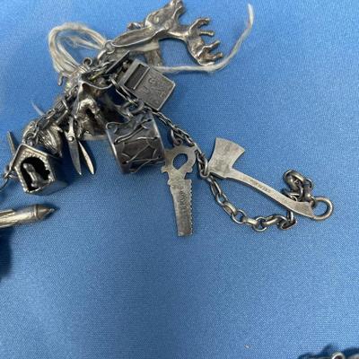 Sale Photo Thumbnail #476: Thought this was a bracelet, until I unfolded it!  Lots of great charms.
Not all charms may be sterling, but the majority of them are.  54.2 grams total weight.