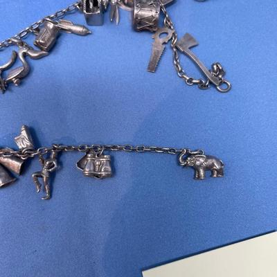 Sale Photo Thumbnail #477: Thought this was a bracelet, until I unfolded it!  Lots of great charms.
Not all charms may be sterling, but the majority of them are.  54.2 grams total weight.