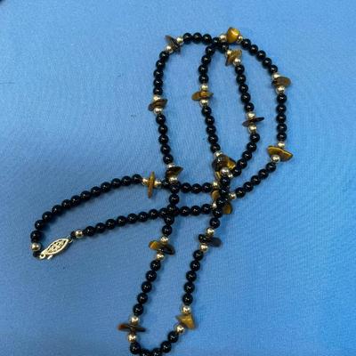 Sale Photo Thumbnail #617: 17.6 grams total weight. 14K gold beads & clasp.  Tiger eye nuggets w/ onyx beads.  Very classy.