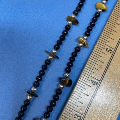 Sale Photo Thumbnail #616: 17.6 grams total weight. 14K gold beads & clasp.  Tiger eye nuggets w/ onyx beads.  Very classy.
