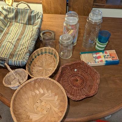 Large basket with jars, vintage party coasters, and other baskets.