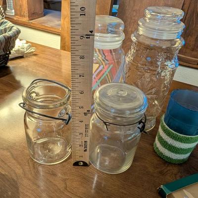 Large basket with jars, vintage party coasters, and other baskets.