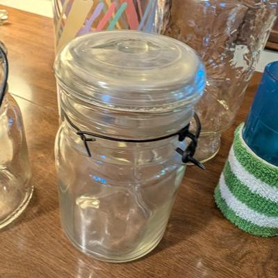 Large basket with jars, vintage party coasters, and other baskets.