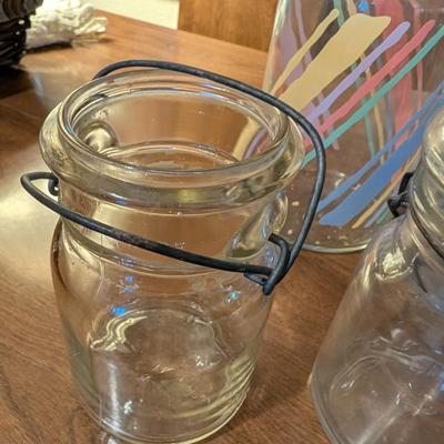 Large basket with jars, vintage party coasters, and other baskets.