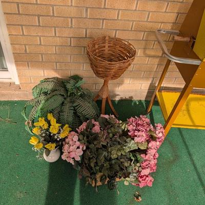 Artificial flowers and fern along with a vintage plant stand.