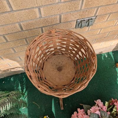 Artificial flowers and fern along with a vintage plant stand.