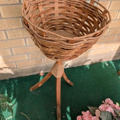 Artificial flowers and fern along with a vintage plant stand.