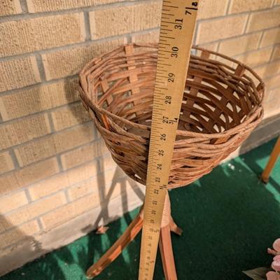 Artificial flowers and fern along with a vintage plant stand.