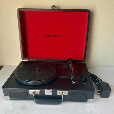 Sale Photo Thumbnail #518: Brief-case style portable turntable with built-in speakers. Has 9V power transformer and cord.  Model CR8005A. †tested, powers on and runs as expected.