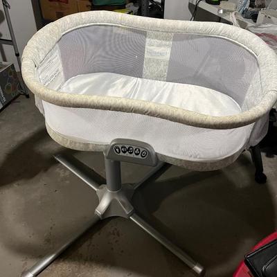 Sale Photo Thumbnail #75: Bassinet rotates around full 360 degrees and can swivel over your bed. Front section does fold down to help with picking up and putting down a baby.  Functions on the front controller all work and include faint lights, heart beat sound maker, volume contr