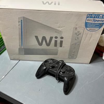 Sale Photo Thumbnail #240: Nintendo Wii gaming console with game controller.  Nunchuck controller, cables, and dock all included.