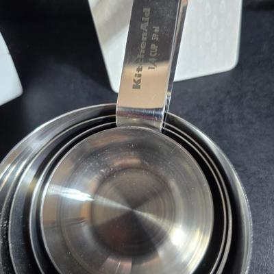 KitchenAid handmixer with new KitchenAid measuring cups, stainless spoons, and a nice stainless bowl