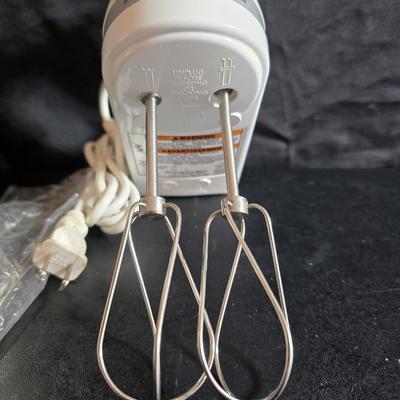 KitchenAid handmixer with new KitchenAid measuring cups, stainless spoons, and a nice stainless bowl