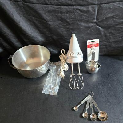 KitchenAid handmixer with new KitchenAid measuring cups, stainless spoons, and a nice stainless bowl