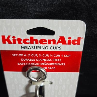 KitchenAid handmixer with new KitchenAid measuring cups, stainless spoons, and a nice stainless bowl