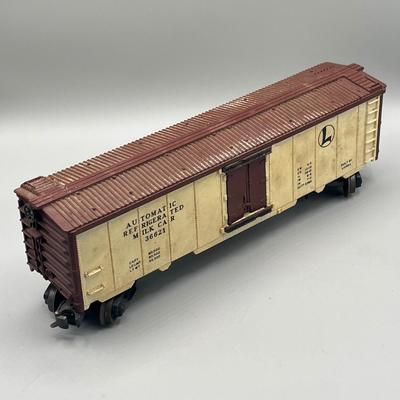 Lot 234: Vintage Lionel Train Cars - Refrigerated Milk Car, Explosives Car Pieces, Caboose and More