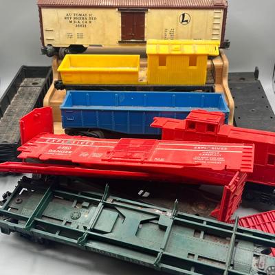 Lot 234: Vintage Lionel Train Cars - Refrigerated Milk Car, Explosives Car Pieces, Caboose and More