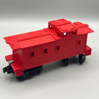 Lot 234: Vintage Lionel Train Cars - Refrigerated Milk Car, Explosives Car Pieces, Caboose and More