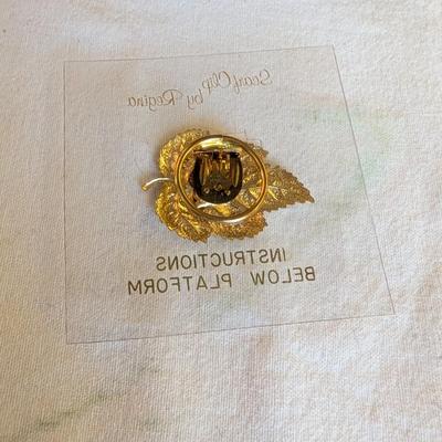 Musical swans, sleeping angel, 40th anniversary plaque, a gold leaf scarf holder.