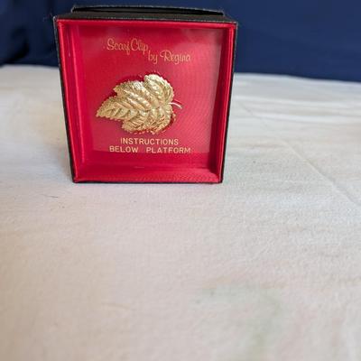 Musical swans, sleeping angel, 40th anniversary plaque, a gold leaf scarf holder.
