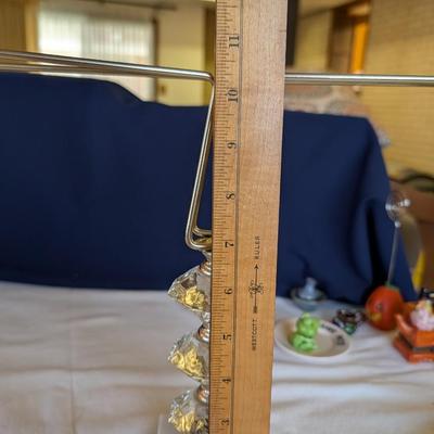 Marble base, glass middle design with gold tone arms. Clear glass diamond point dish with marble base.