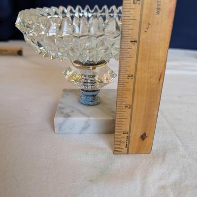 Marble base, glass middle design with gold tone arms. Clear glass diamond point dish with marble base.